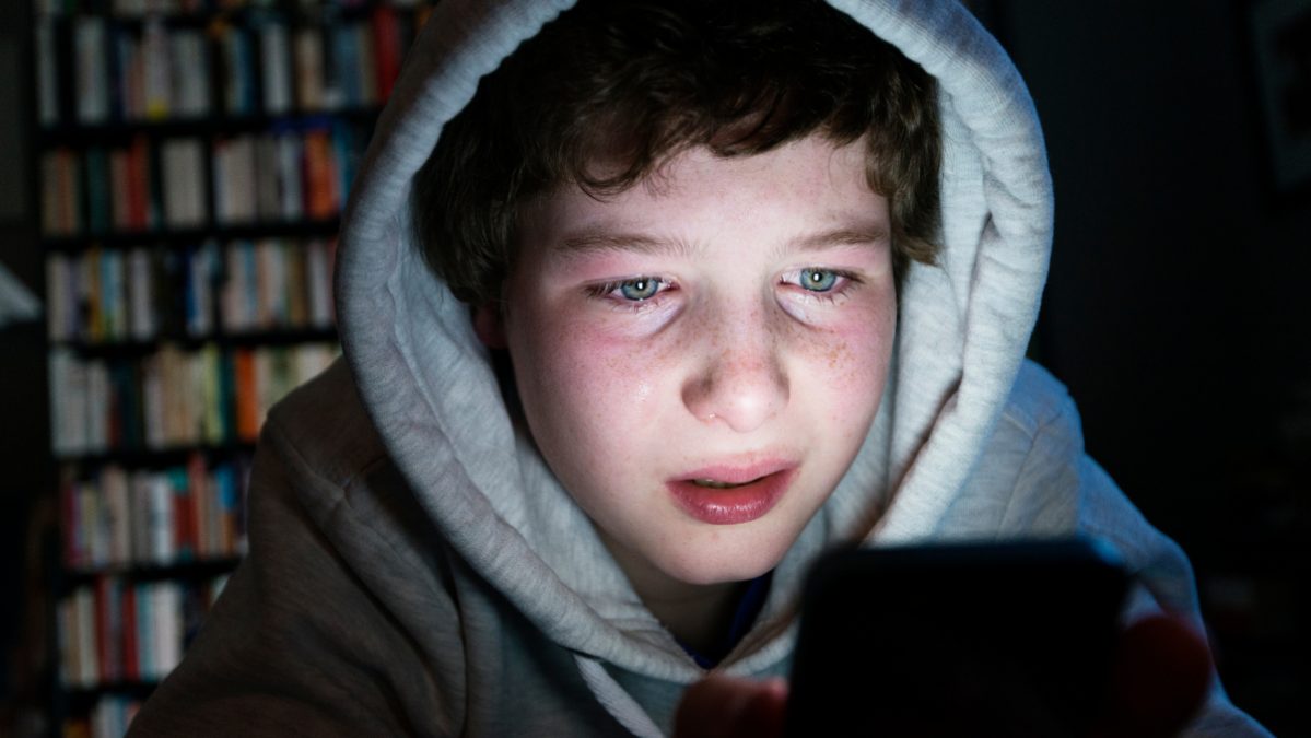 Young boy upset from cyberbullying