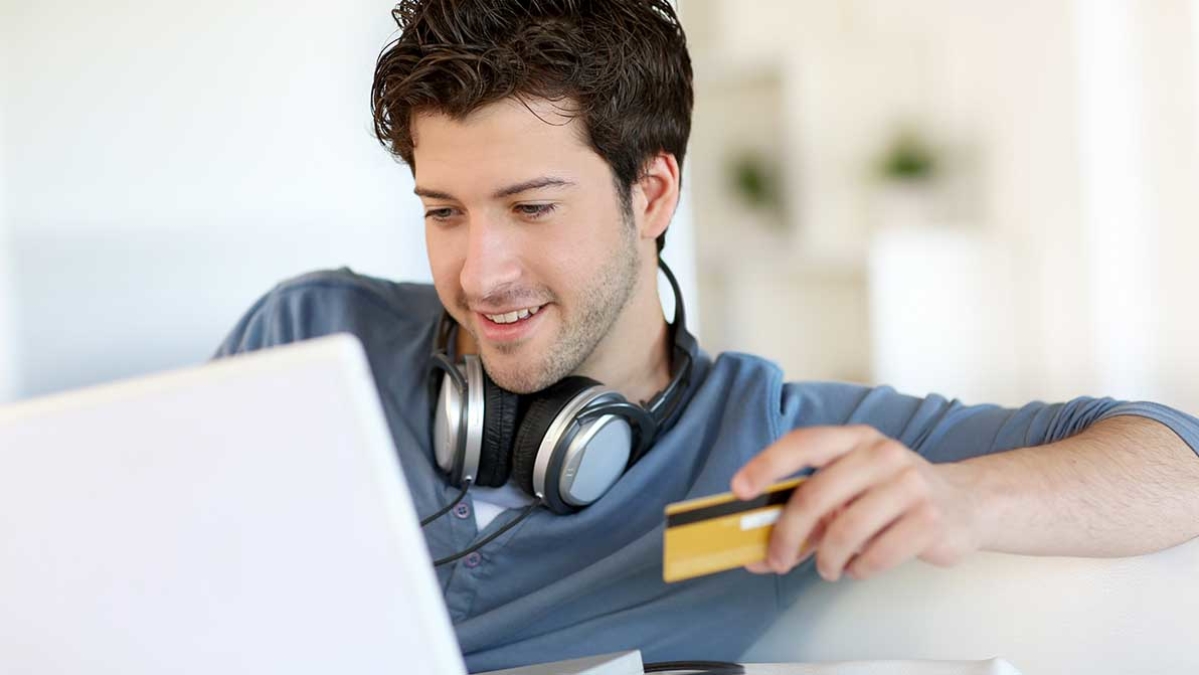 Man with credit card shopping on internet