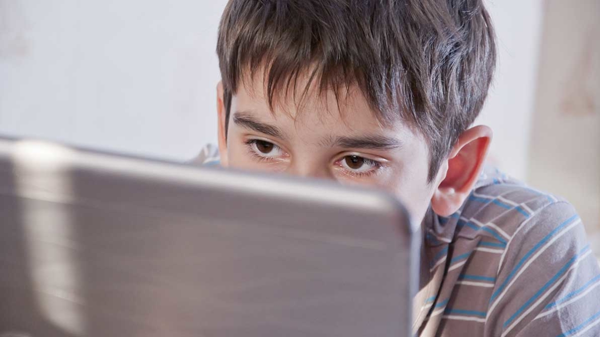 Teenage boy using laptop
