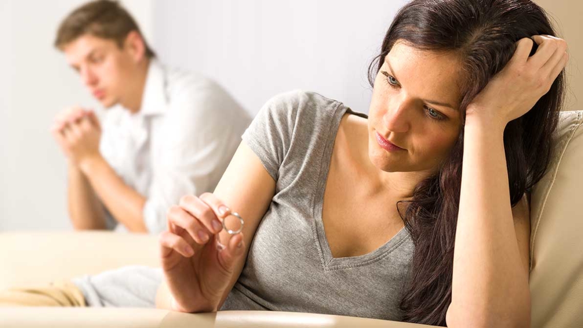 Woman playing with ring and man in background