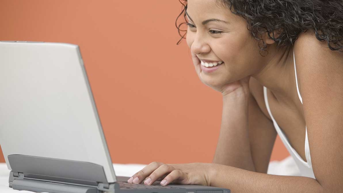 teenage girl using her laptop