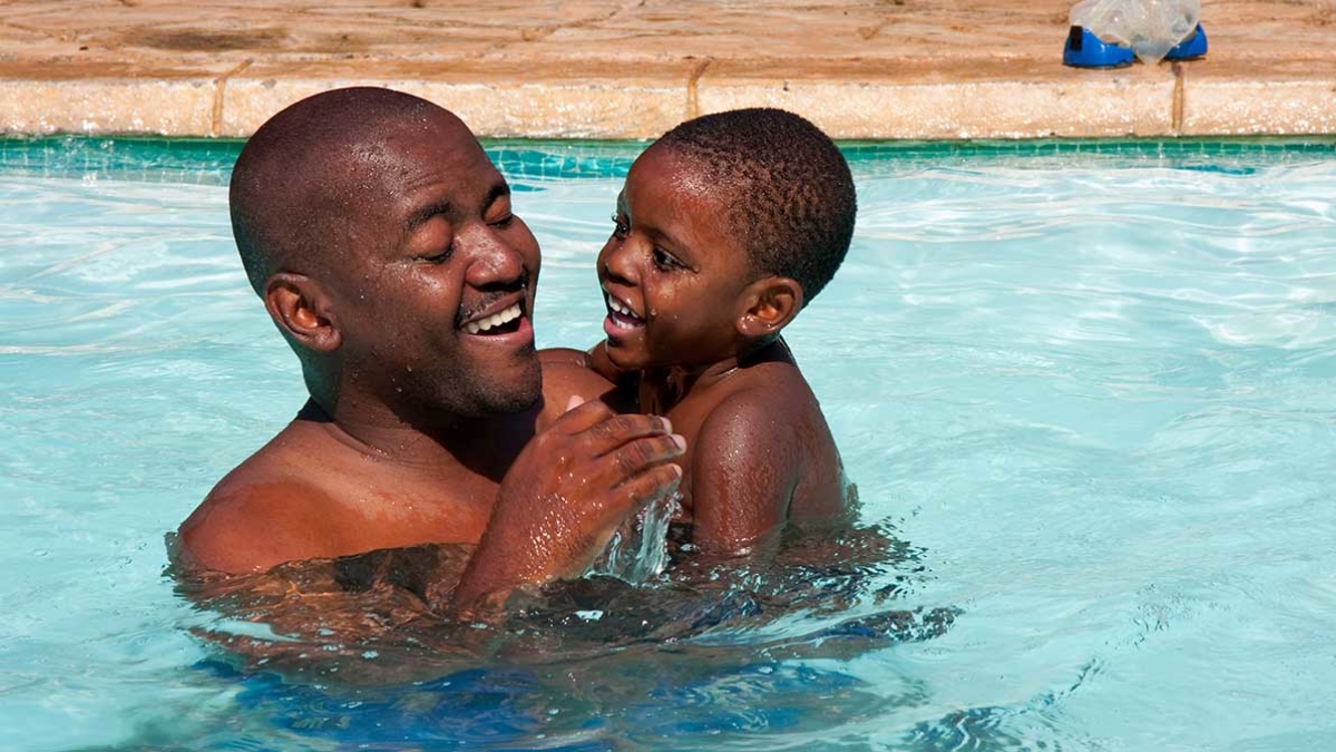 Dad and son in swimming pool